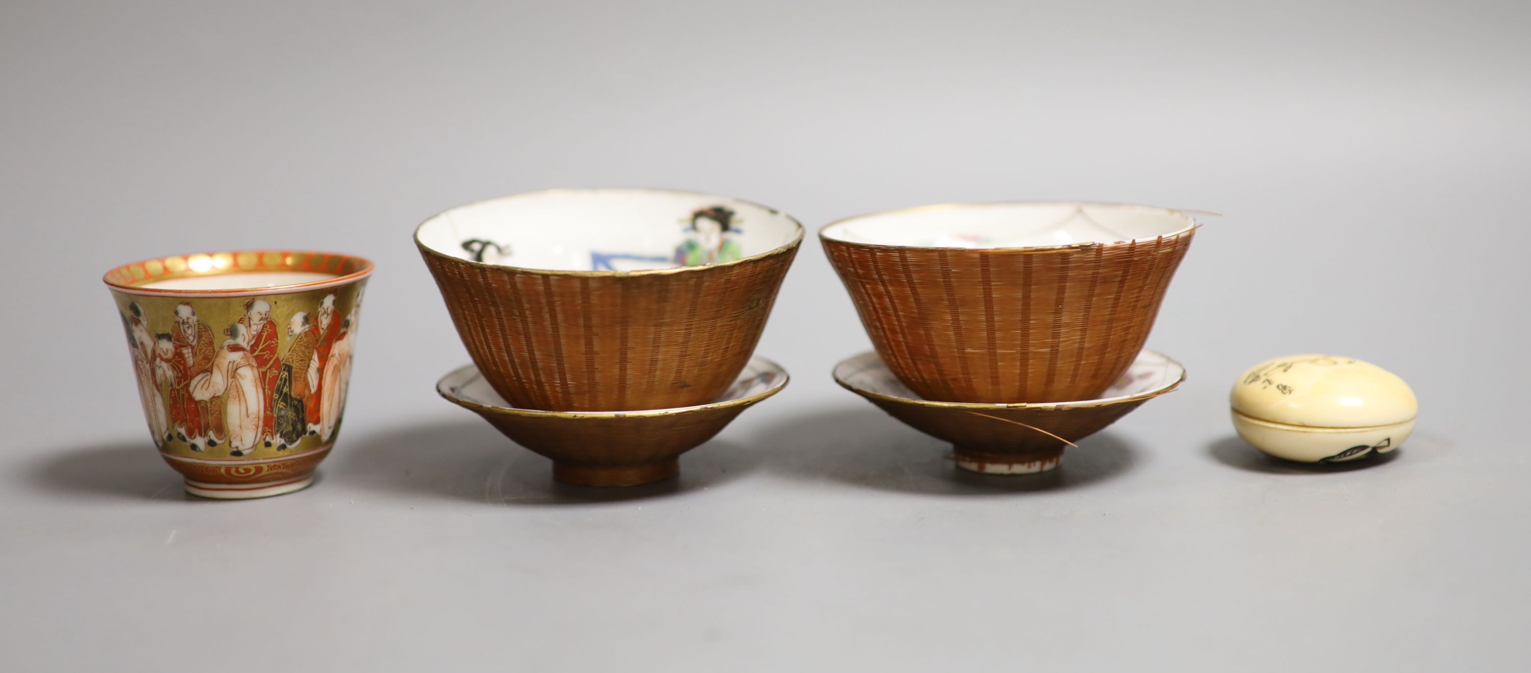 A Japanese ivory manju shaped okimono, three cups & two saucers, all Meiji period.